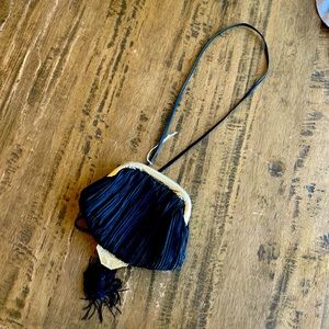 Fashionable black back with gold and string detailing!